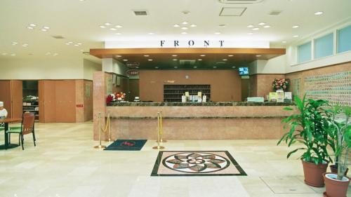 a hotel lobby with a front counter and a restaurant at Toyoko Inn Yokohama Kannai in Yokohama