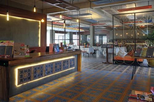 a restaurant with a bar and a dining room at Central Corner Suite in Siem Reap