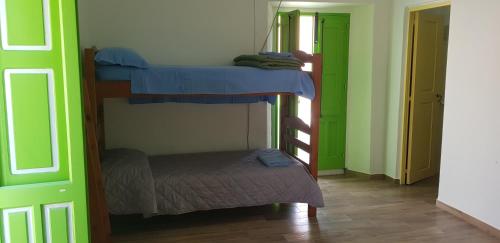 two bunk beds in a room with a small bed at Da Luciano in Stromboli
