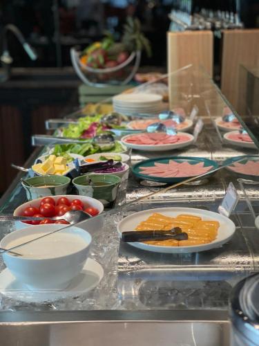 a buffet with plates of food on a table at Oakwood Residence Saigon in Ho Chi Minh City