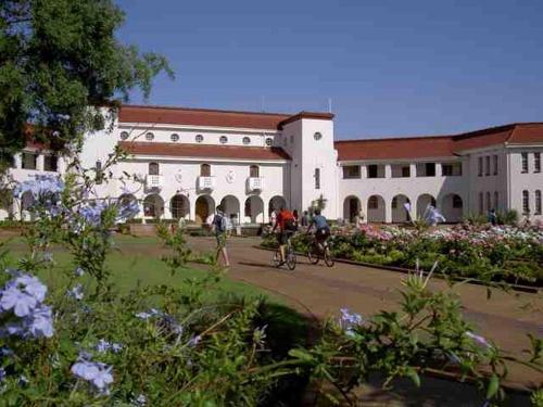 a group of people riding bikes in front of a building at Cosy - Best Rest Potch in Potchefstroom
