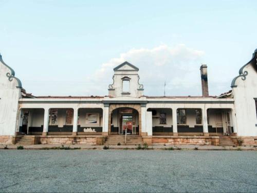 an old building with a clock tower on top of it at Cosy - Best Rest Potch in Potchefstroom