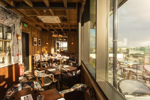a restaurant with tables and chairs and a window at The Dean Galway in Galway