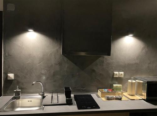 a kitchen counter with a sink and a microwave at Meteora Studio by Meteora Residencies in Kalabaka