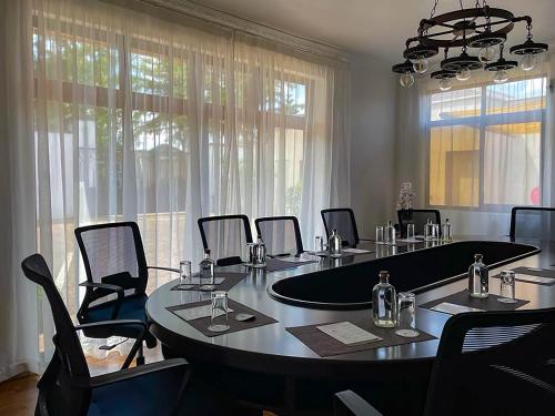 a meeting room with a large table and chairs at Bamboo Boutique Hotel in Lilongwe