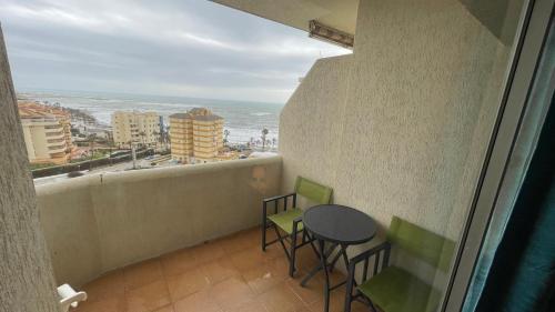 a balcony with a table and chairs and the ocean at estudio con vista al mar 19 in Benalmádena