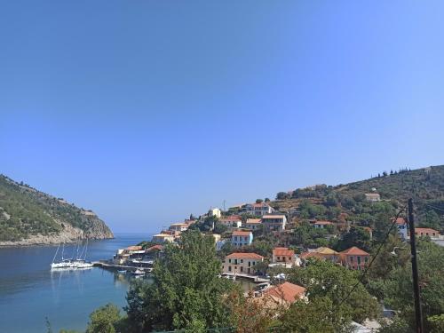 a small town on a hill next to the water at Panorama Apartments in Asos