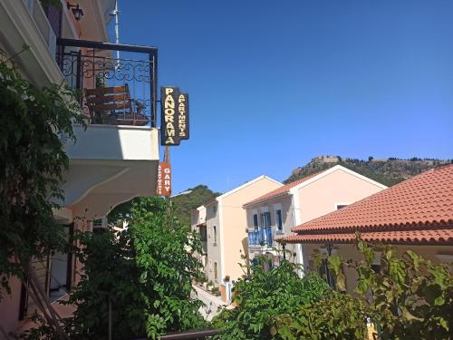 a group of buildings with a sign on a balcony at Panorama Apartments in Asos