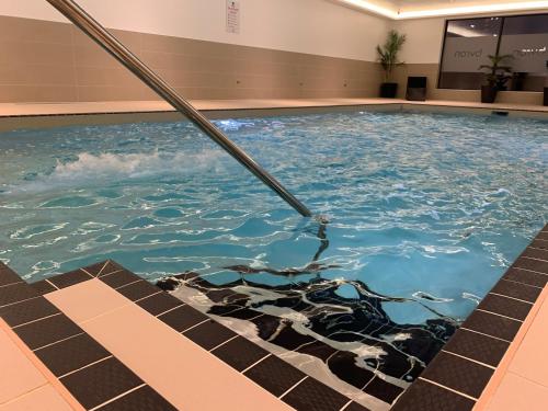 a pool of water in a building at 1 Rockham - Luxury Apartment at Byron Woolacombe, only 4 minute walk to Woolacombe Beach! in Woolacombe