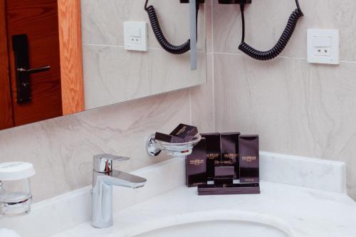 a bathroom with a sink and a mirror at Premium Hotel Ganja in Ganja