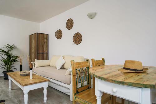 a living room with a couch and a table at Exi Sea Side Suites in Perissa