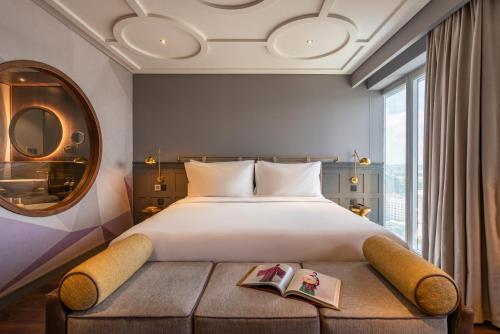 a bedroom with a large bed and a large window at Fusion Original Saigon Centre in Ho Chi Minh City