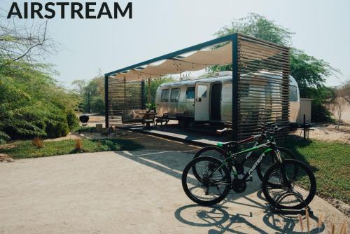 a bike is parked in front of a shed at Bab Al Nojoum Al Mugheirah in Al Mirfa