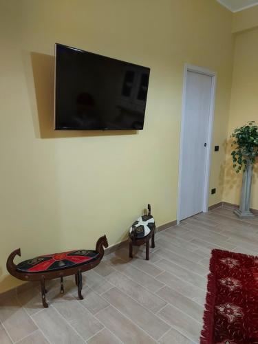 a living room with a flat screen tv on the wall at Casa da Flo' in Augusta