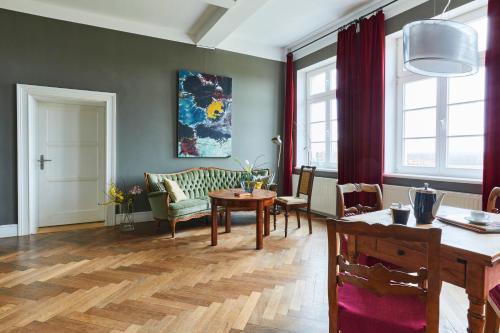 a living room with a table and a dining room at Gut Pohnstorf in Alt Sührkow