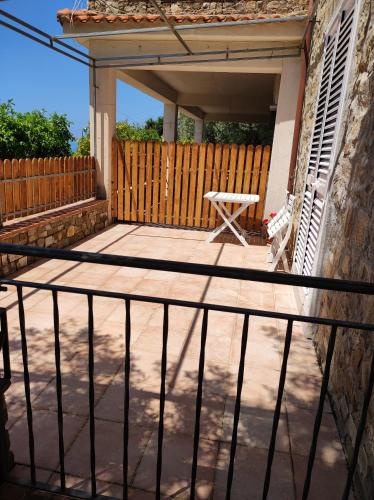 a patio with a bench and a fence at IL CONTE DI MARRAONE in Agnone
