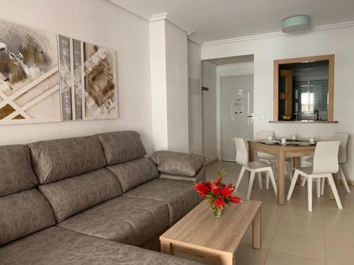 a living room with a couch and a table at Sonata first line apartment in El Borseral