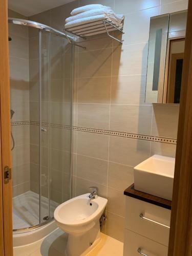 a bathroom with a shower and a toilet and a sink at Sonata first line apartment in El Borseral