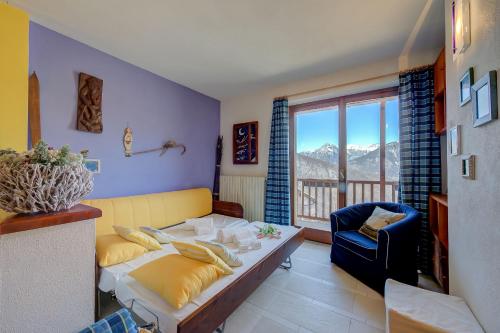 a living room with a couch and a chair at Rebecca's House few steps from skiing - Happy Rentals in Bardonecchia