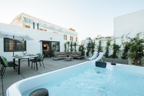 a pool on the roof of a building at Guadalupe 15 by Magno Apartments in Seville