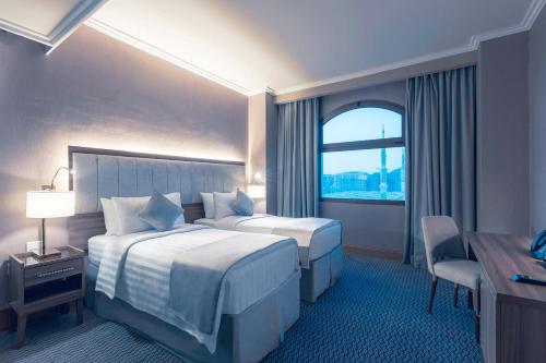 メディナにあるMysk Touch Al Baladのベッド2台と窓が備わるホテルルームです。