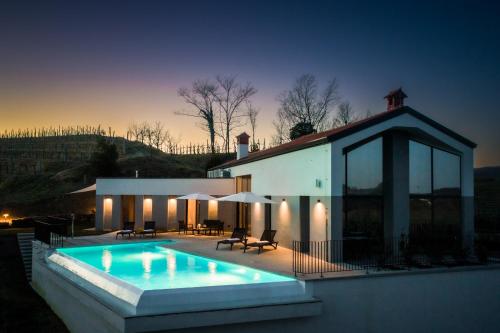 a house with a swimming pool in front of it at Larya House in Dobrovo