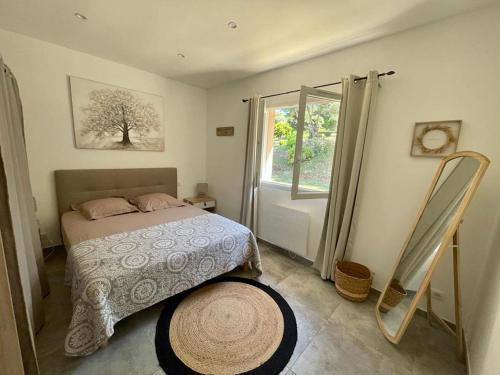a bedroom with a bed and a window at Case Di A Cappana-Villa CARLA in Bonifacio