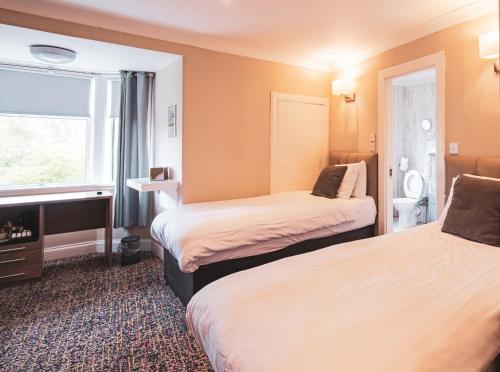 Ένα ή περισσότερα κρεβάτια σε δωμάτιο στο Albion Hotel