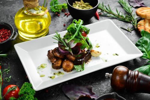 a white plate with food on a table at Курортний Готель Золота Корона in Truskavets