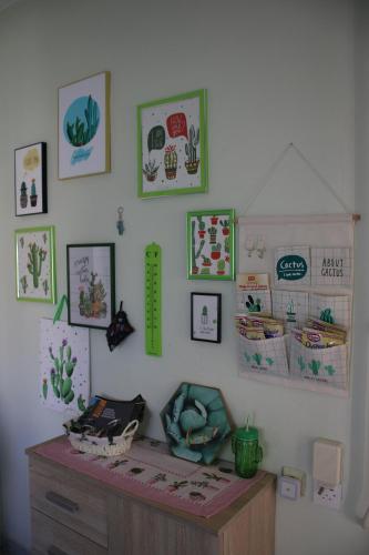 a room with a desk and pictures on the wall at Green Cactus Rooms - unique and cozy house in Senta
