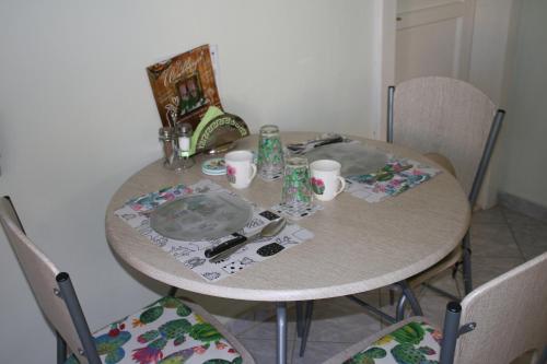 a dining room table with a table and chairs at Green Cactus Rooms - unique and cozy house in Senta