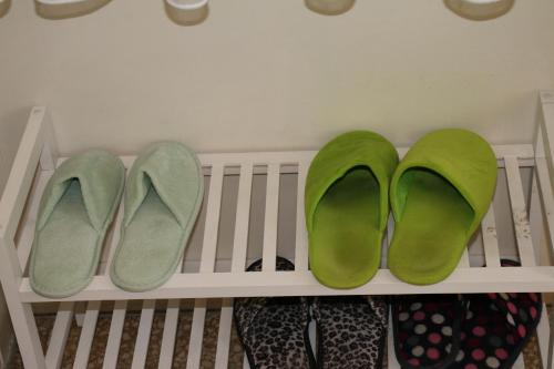 a pair of green shoes sitting on a crib at Green Cactus Rooms - unique and cozy house in Senta