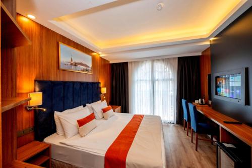 a hotel room with a bed and a television at Harmony Hotel Istanbul & SPA in Istanbul