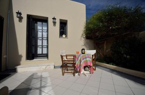 a table and chairs sitting on a patio at Knossos Palace Secluded Villa in Skalánion