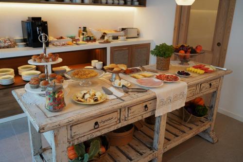 a table with food on it in a kitchen at Hotel S'Antiga Adults Only in Es Mercadal