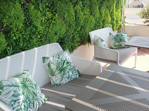 a patio with two chairs and a table with pillows at 7Rizes Luxury Living in Heraklio Town