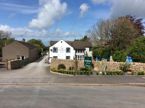 a white house with a stone fence in front of it at Lake District Western 2-Bed Cabin Pet Friendly in Wigton