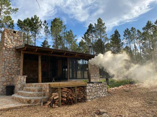 a house with smoke coming out of it at Krakeelpoort Herberg in Botrivier