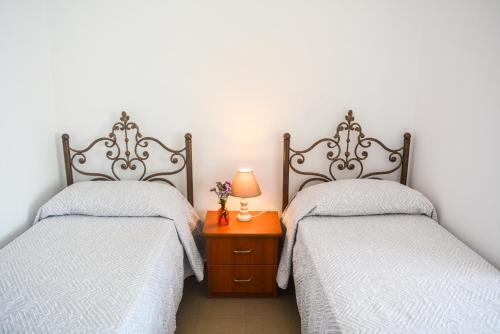 2 nebeneinander sitzende Betten in einem Schlafzimmer in der Unterkunft Chiara Lovely Apartment in Tirana