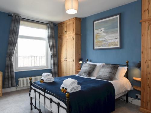 a blue bedroom with a bed with two toy cars on it at Pass the Keys Modern Seafront Apartment With Great Views Sleeps 4 in Portsmouth