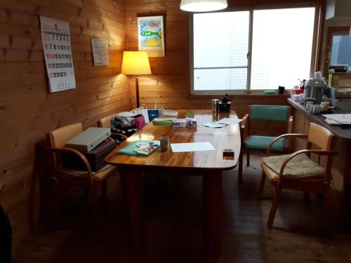 an office with a wooden table and chairs at 春日ハウス KasugaHouse in Tsukuba