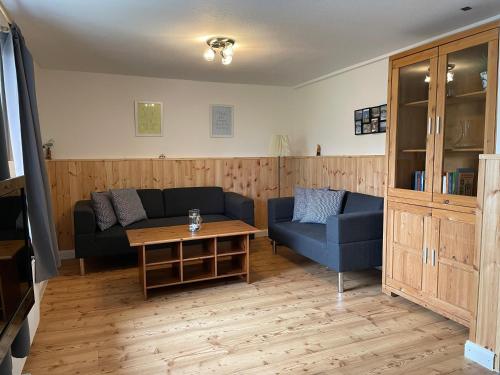 a living room with a couch and a table at Lindenhof Habernis in Steinberg