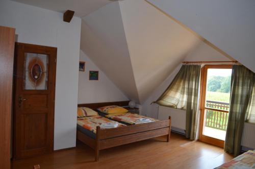 a bedroom with a bed and a staircase with a window at Famozclub in Bakov nad Jizerou