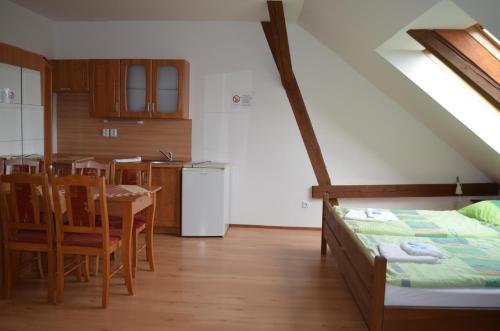 a kitchen and dining room with a bed and a table at Famozclub in Bakov nad Jizerou