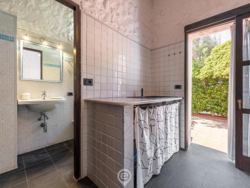 a bathroom with a sink and a mirror at House Eleonora in Cala Sapone
