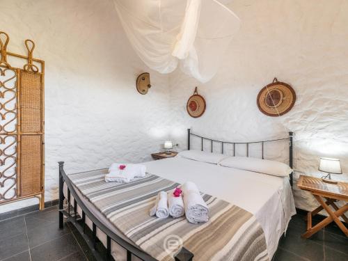 a bedroom with two beds with towels on them at House Eleonora in Cala Sapone