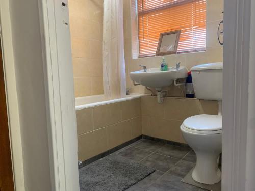 a bathroom with a toilet and a sink at Hikers & Bikers Refuge in Ipswich