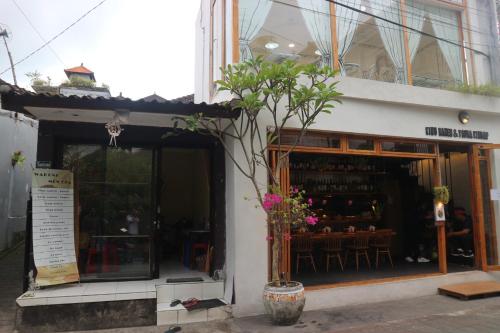 a store front with a potted tree in front of it at Sudana Homestay in Ubud City in Ubud
