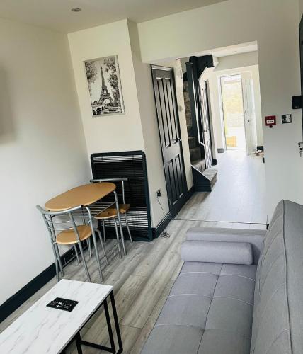 ein Wohnzimmer mit Sofa und Tisch in der Unterkunft Wadhurst - Stunning 4 bed (all en-suite) house in Aveley