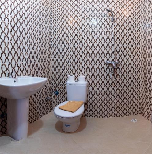 a bathroom with a toilet and a sink at Azrac Surf Morocco in Agadir